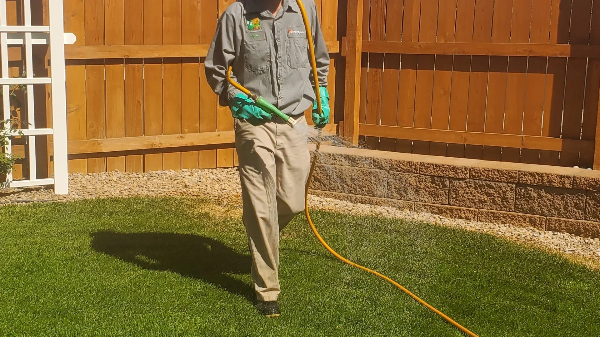 Professional applying pre-emergent weed control treatment to a lawn in Grand Junction, CO.