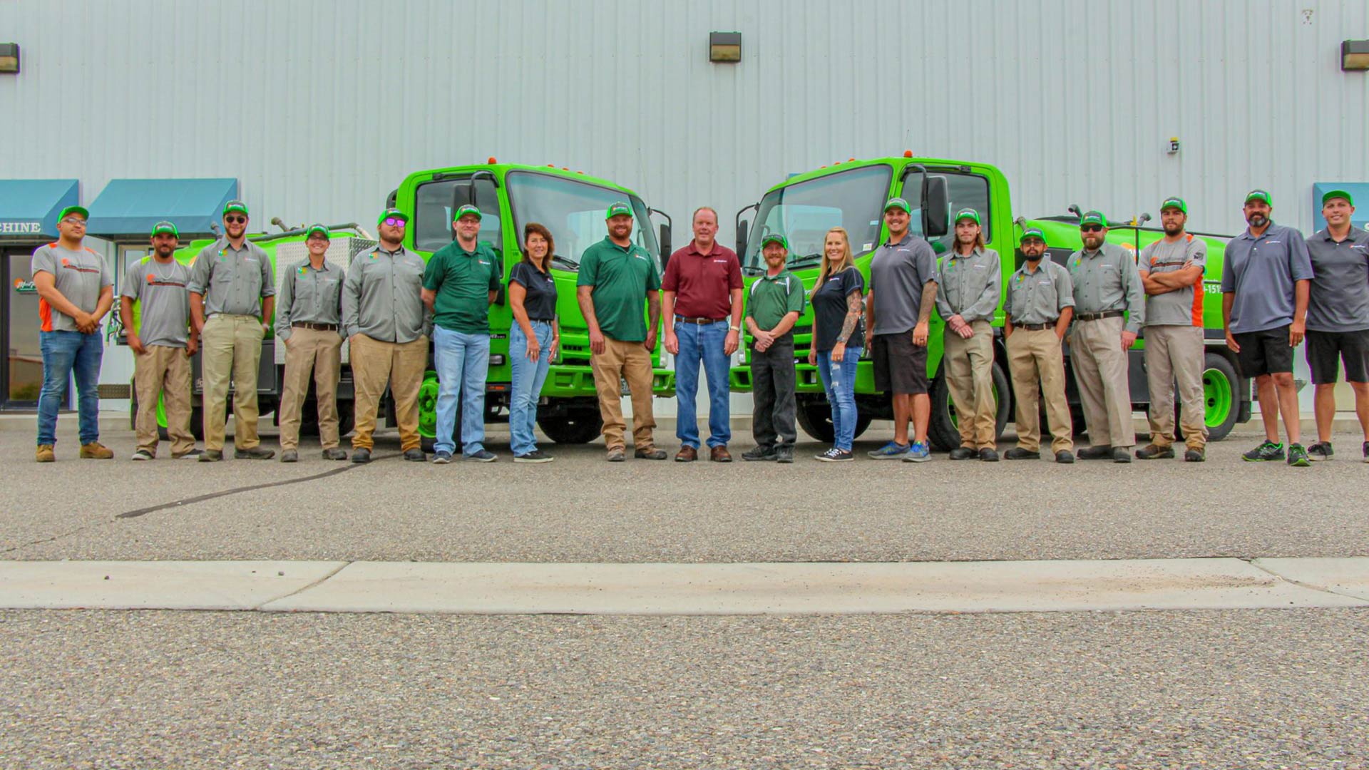 The Mesa Turf Masters team with their work trucks and office in the background near Grand Junction, CO.