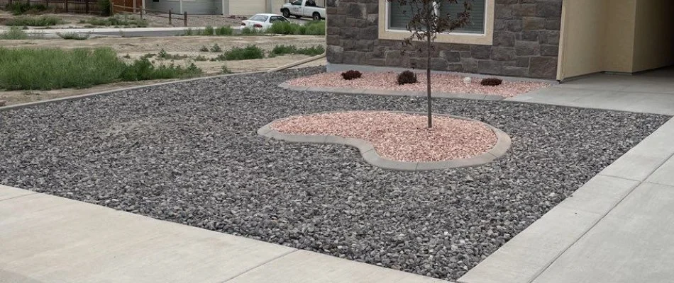 Black, blue, and pink rocks in a front yard in Grand Junction, CO.