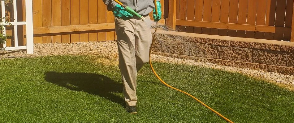 Employee spraying a lawn with fertilizer in Grand Junction, CO.