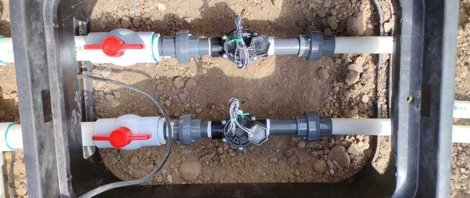 Irrigation system valves and control box being installed in the ground in Palisade, CO.