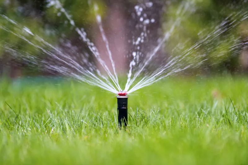 Pop-up sprinkler with gear-driven nozzle